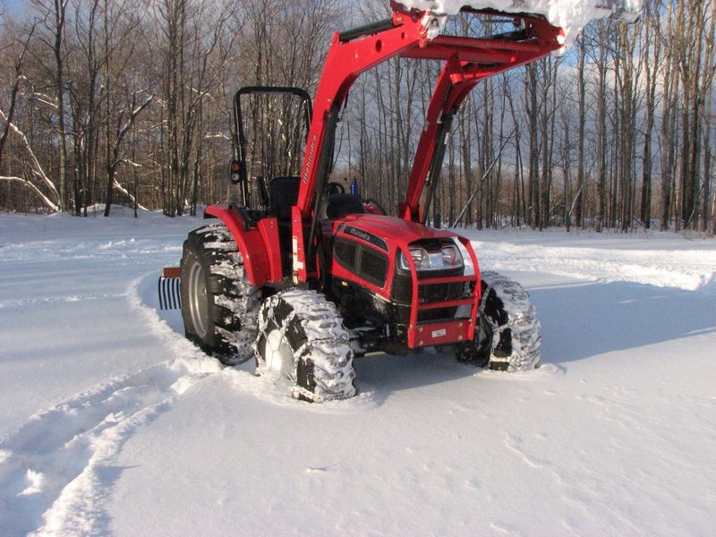 Mahindra tractor with loader in the snow.
